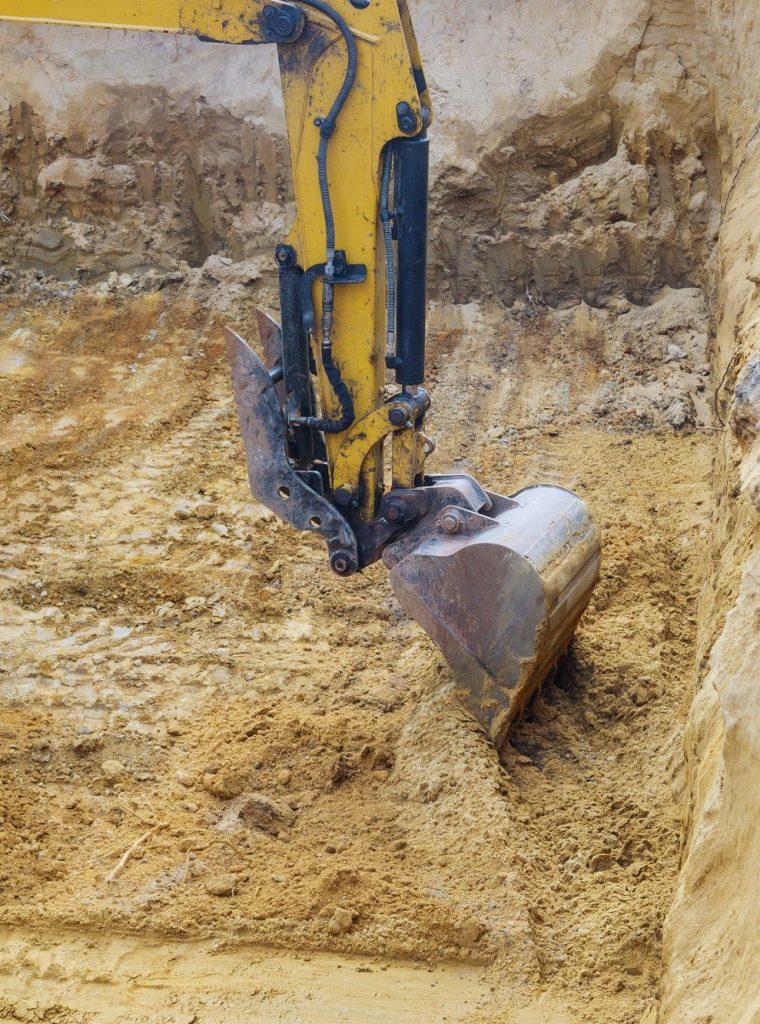Construction with pile foundation at ground completed on excavator at earthworks